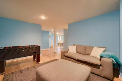 a living room with a couch and a giant screen at West Dover Family Home with Game Room and Home Theater in West Dover