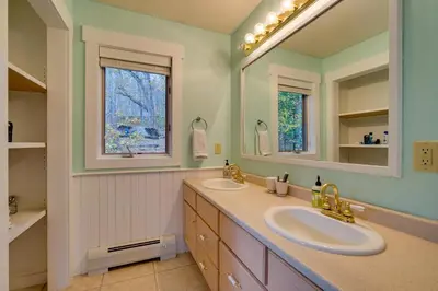a bathroom with two sinks and a large mirror at West Dover Family Home with Game Room and Home Theater in West Dover