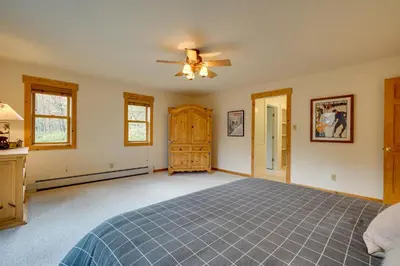 a bedroom with a bed and a ceiling fan at West Dover Family Home with Game Room and Home Theater in West Dover