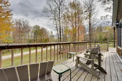 a deck with chairs and a table and a bench at West Dover Family Home with Game Room and Home Theater in West Dover