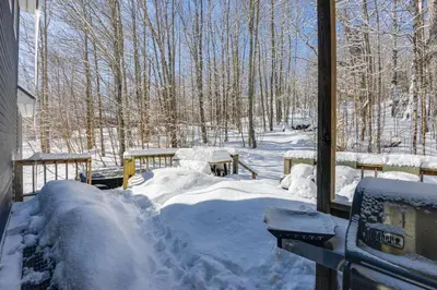 a pile of snow on a porch of a house at West Dover Family Home with Game Room and Home Theater in West Dover