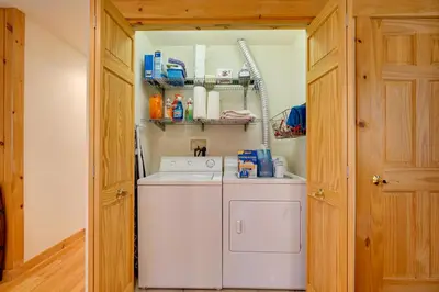 a washer and dryer in a small laundry room at West Dover Family Home with Game Room and Home Theater in West Dover