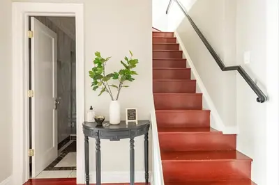 a stairway with a table with a plant on it at Lofty & Bright Greenwich Getaway w Private Rooftop in New York