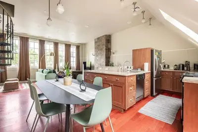 a kitchen with a table and chairs in a room at Lofty & Bright Greenwich Getaway w Private Rooftop in New York