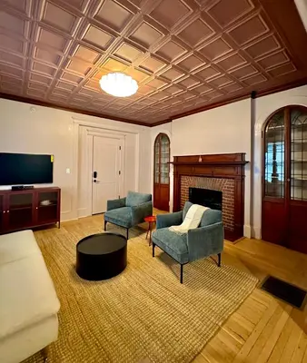 a living room with two chairs and a tv at CoHouse New Haven steps to Yale University in New Haven