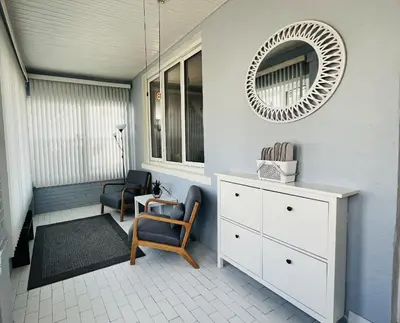 a room with a mirror and a dresser and chairs at Cozy Home close to New York City in Fairview