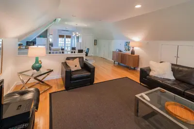 a living room with two leather chairs and a couch at The Carriage House Loft in Kingston