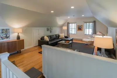 a living room with a couch and a table at The Carriage House Loft in Kingston