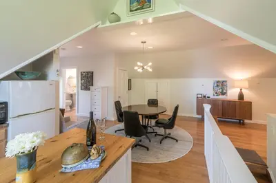 a kitchen and living room with a table and chairs at The Carriage House Loft in Kingston