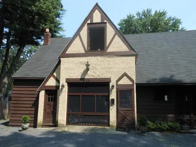 a house with a garage and a roof at The Carriage House Loft in Kingston