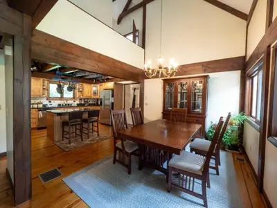 a dining room with a wooden table and chairs at Berkshire Vacation Rentals: Pristine Home In Becket Woods in Becket