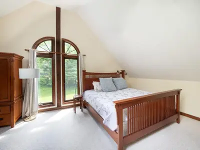 a bedroom with a bed and a window at Berkshire Vacation Rentals: Pristine Home In Becket Woods in Becket
