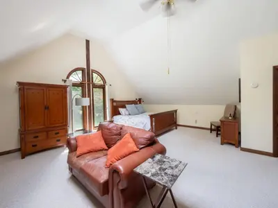 a living room with a couch and a bed at Berkshire Vacation Rentals: Pristine Home In Becket Woods in Becket