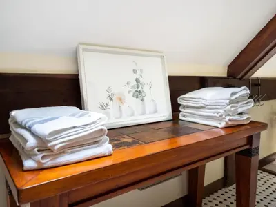 two stacks of towels sitting on a wooden table at Berkshire Vacation Rentals: Pristine Home In Becket Woods in Becket
