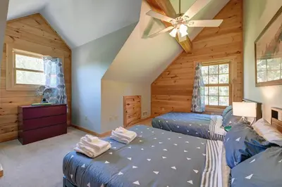 a bedroom with two beds and a ceiling fan at Berkshire Vacation Rentals: Great Barrington Cabin Sleeps 14 Walk To Town in Great Barrington