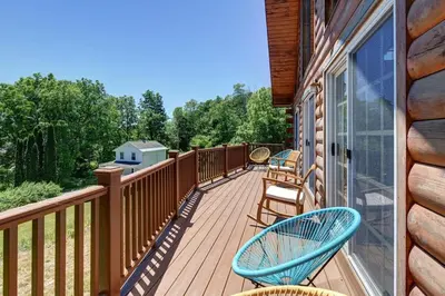 a deck with two chairs and a window at Berkshire Vacation Rentals: Great Barrington Cabin Sleeps 14 Walk To Town in Great Barrington
