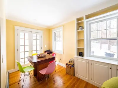 a dining room with a wooden table and chairs at Classic Stockbridge Cottage in Stockbridge