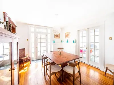 a dining room with a wooden table and chairs at Classic Stockbridge Cottage in Stockbridge
