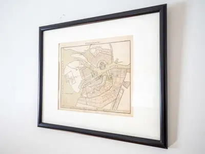 a framed map of a city in a frame on a wall at Classic Stockbridge Cottage in Stockbridge