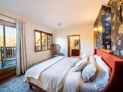 a bedroom with a bed with white sheets and a window at Private Berkshires Home On 5+ Acres Rustic & Chic in Otis