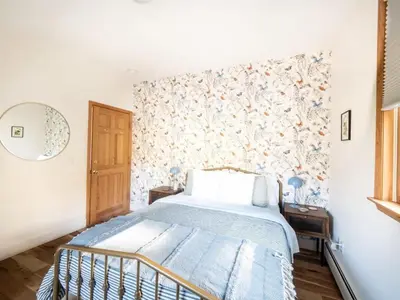 a bedroom with a bed with a floral wallpaper at Private Berkshires Home On 5+ Acres Rustic & Chic in Otis