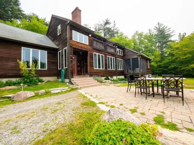 a house with a table and chairs in front of it at Private Berkshires Home On 5+ Acres Rustic & Chic in Otis