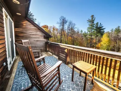 a porch with two chairs and a table on it at Private Berkshires Home On 5+ Acres Rustic & Chic in Otis