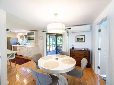 a kitchen and dining room with a white table and chairs at Berkshire Vacation Rental: Stockbridge Home Come Experience The Berkshires in Stockbridge