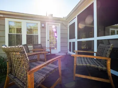 a porch with chairs and tables on a house at Berkshire Vacation Rental: Stockbridge Home Come Experience The Berkshires in Stockbridge