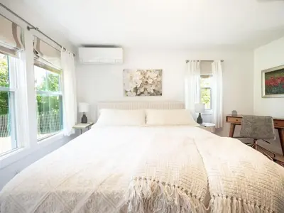 a white bedroom with a large bed with windows at Berkshire Vacation Rental: Stockbridge Home Come Experience The Berkshires in Stockbridge