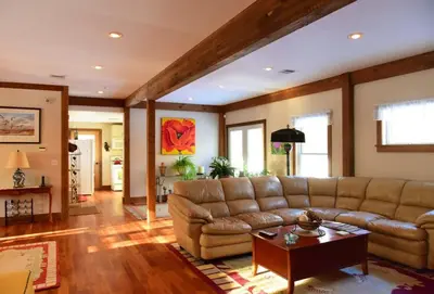 a living room with a couch and a table at Berkshire Vacation Rentals: Peaceful Post and Beam Loft Sleeps 9 in New Marlborough