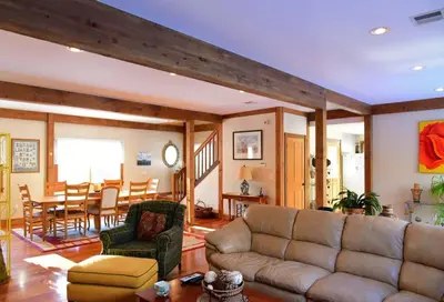 a living room with a couch and a table at Berkshire Vacation Rentals: Peaceful Post and Beam Loft Sleeps 9 in New Marlborough