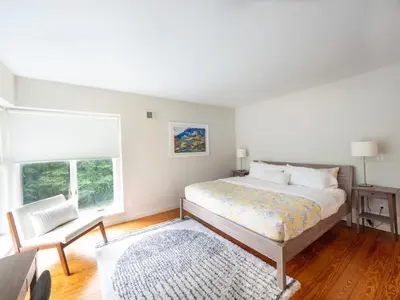 a bedroom with a bed and a table and a chair at Berkshire Vacation Rentals: High End Berkshires Getaway in East Hillsdale