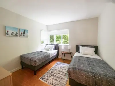 a bedroom with two beds and a window at Berkshire Vacation Rentals: High End Berkshires Getaway in East Hillsdale