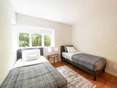 a bedroom with two beds and a window at Berkshire Vacation Rentals: High End Berkshires Getaway in East Hillsdale