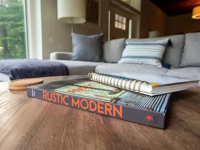 a book sitting on top of a coffee table at Berkshire Vacation Rentals: High End Berkshires Getaway in East Hillsdale