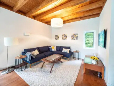 a living room with a blue couch and a table at Berkshire Vacation Rentals: High End Berkshires Getaway in East Hillsdale