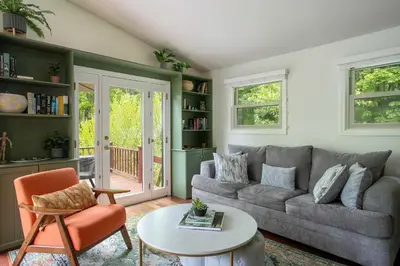 a living room with a couch and a table at Berkshire Vacation Rentals: Great Barrington Walkable To Lake And Town in Great Barrington