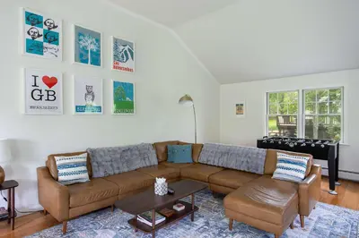 a living room with a brown couch and chairs at Berkshire Vacation Rentals: Great Barrington Walkable To Lake And Town in Great Barrington