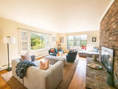 a living room with a couch and a fireplace at Berkshire Vacation Rentals: Renovated Five Bedrooms In Historic Williamstown in Williamstown