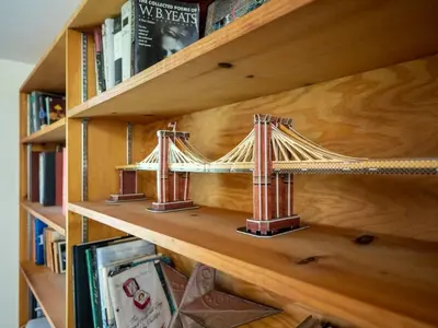 a wooden book shelf with a model of a bridge at Berkshire Vacation Rentals: Renovated Five Bedrooms In Historic Williamstown in Williamstown