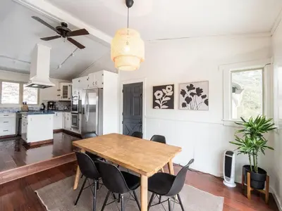 a kitchen and dining room with a wooden table and chairs at Berkshire Vacation Rentals: Chic Pittsfield Home With A View in Pittsfield