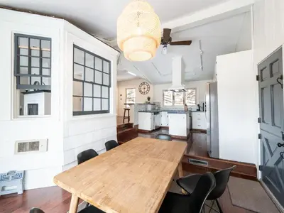a dining room with a wooden table and chairs at Berkshire Vacation Rentals: Chic Pittsfield Home With A View in Pittsfield
