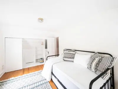 a white bedroom with a bed with pillows on it at Berkshire Vacation Rentals: Chic Pittsfield Home With A View in Pittsfield