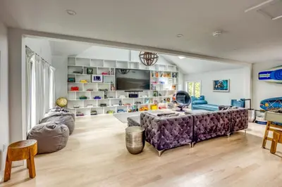 a living room with a large purple couch and chairs at Berkshire Vacation Rentals: The Brookman: Renovated 6000 SF Estate On 40 Acres in Williamstown