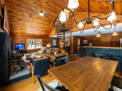 a dining room and living room with a wooden ceiling at Berkshire Vacation Rentals: Private Cabin On Over 12 Acres Of Woods in Becket