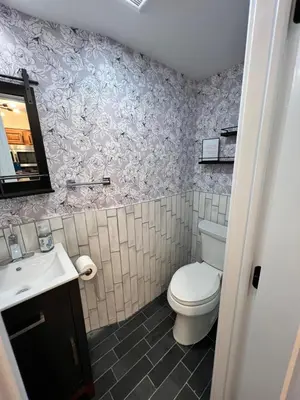 a bathroom with a toilet and a sink at 10Min to NYC - 2BR/2.5Bath-3Beds-Free Parking-No Chores in Hoboken