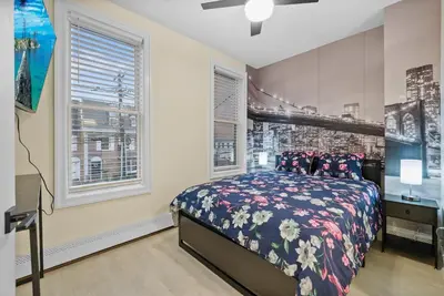 a bedroom with a bed and two windows at 10Min to NYC - 2BR/2.5Bath-3Beds-Free Parking-No Chores in Hoboken