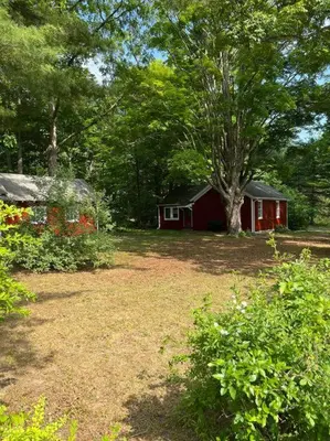 a small red house in the middle of a yard at Schoolhouse No. 11 * Hudson Valley Upstate Getaway in Stone Ridge