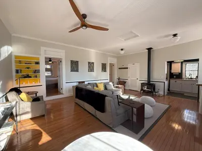 a living room with a couch and a ceiling fan at Schoolhouse No. 11 * Hudson Valley Upstate Getaway in Stone Ridge